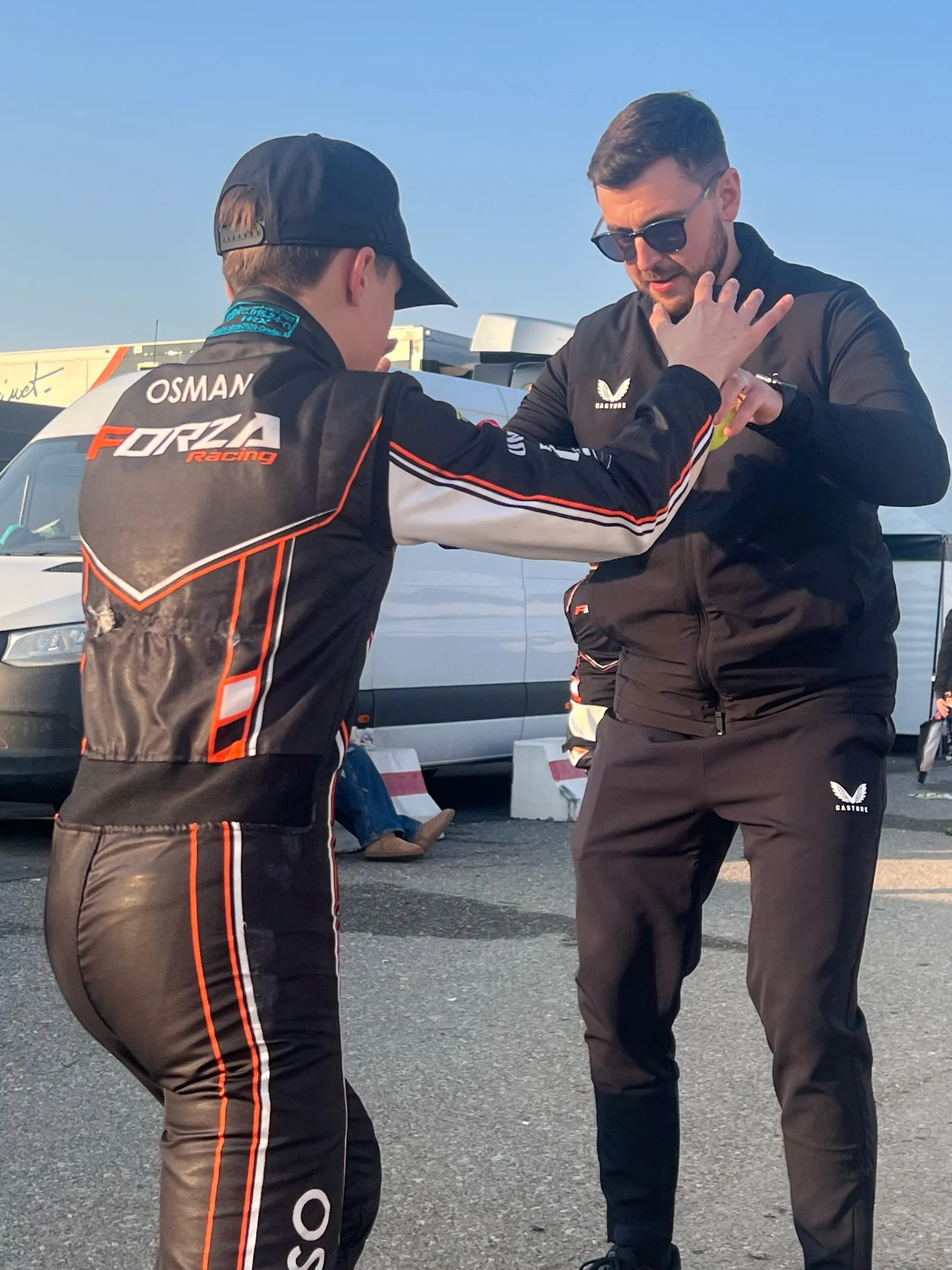 Coach running a pre-session activation drill with a karting driver