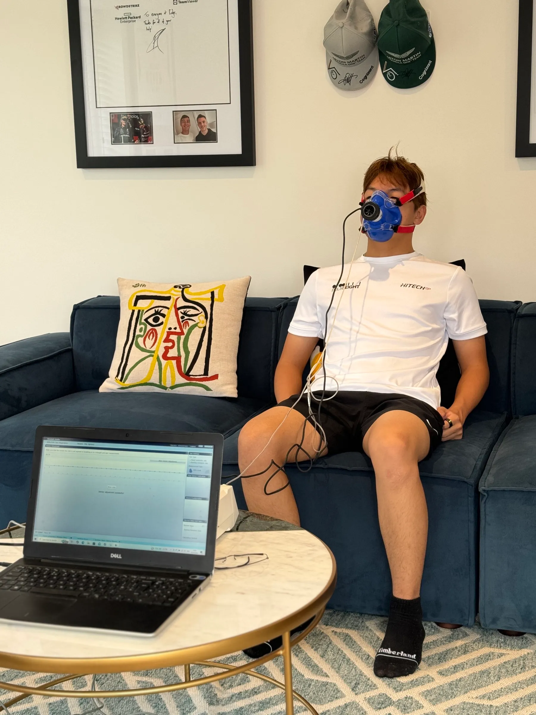 Driver wearing a monitoring headset while reviewing data on a laptop