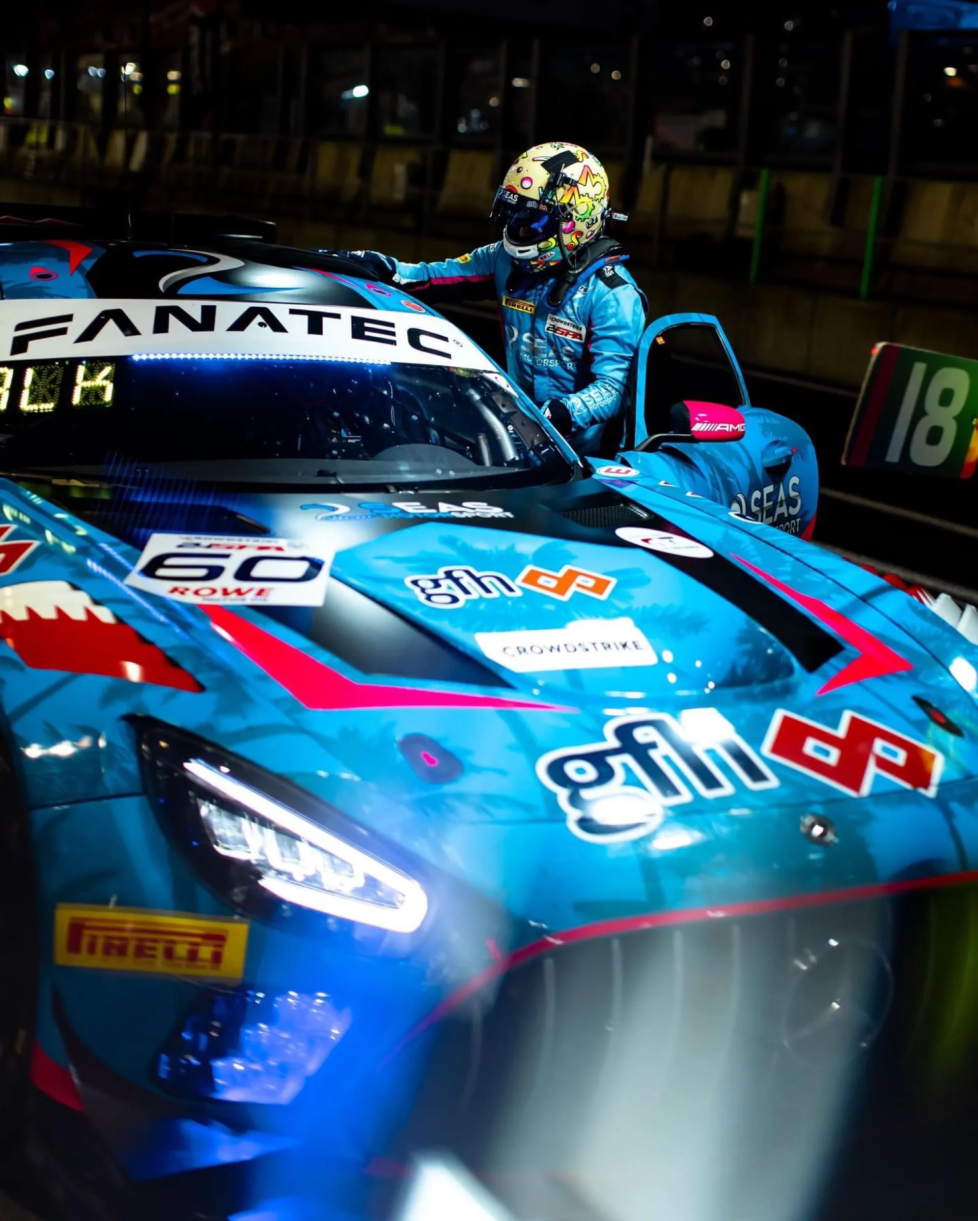 GT3 driver climbing out of the car in the pit lane