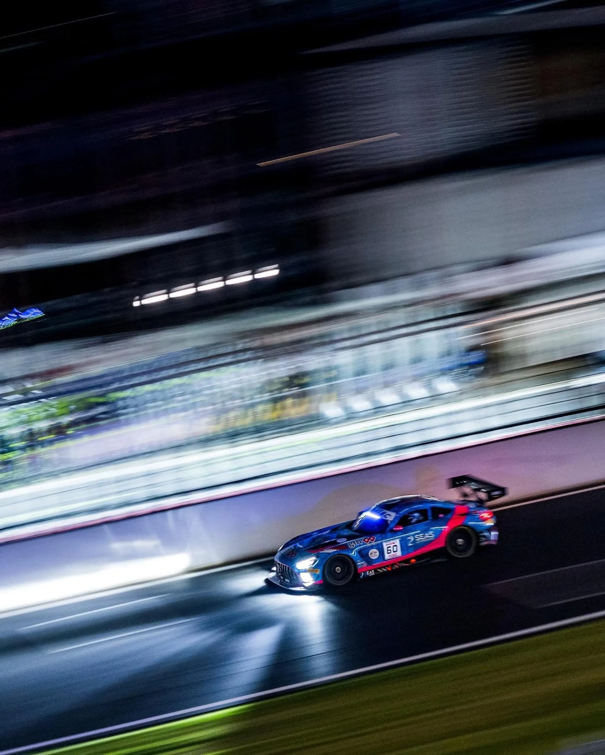 GT3 car at speed under lights at night