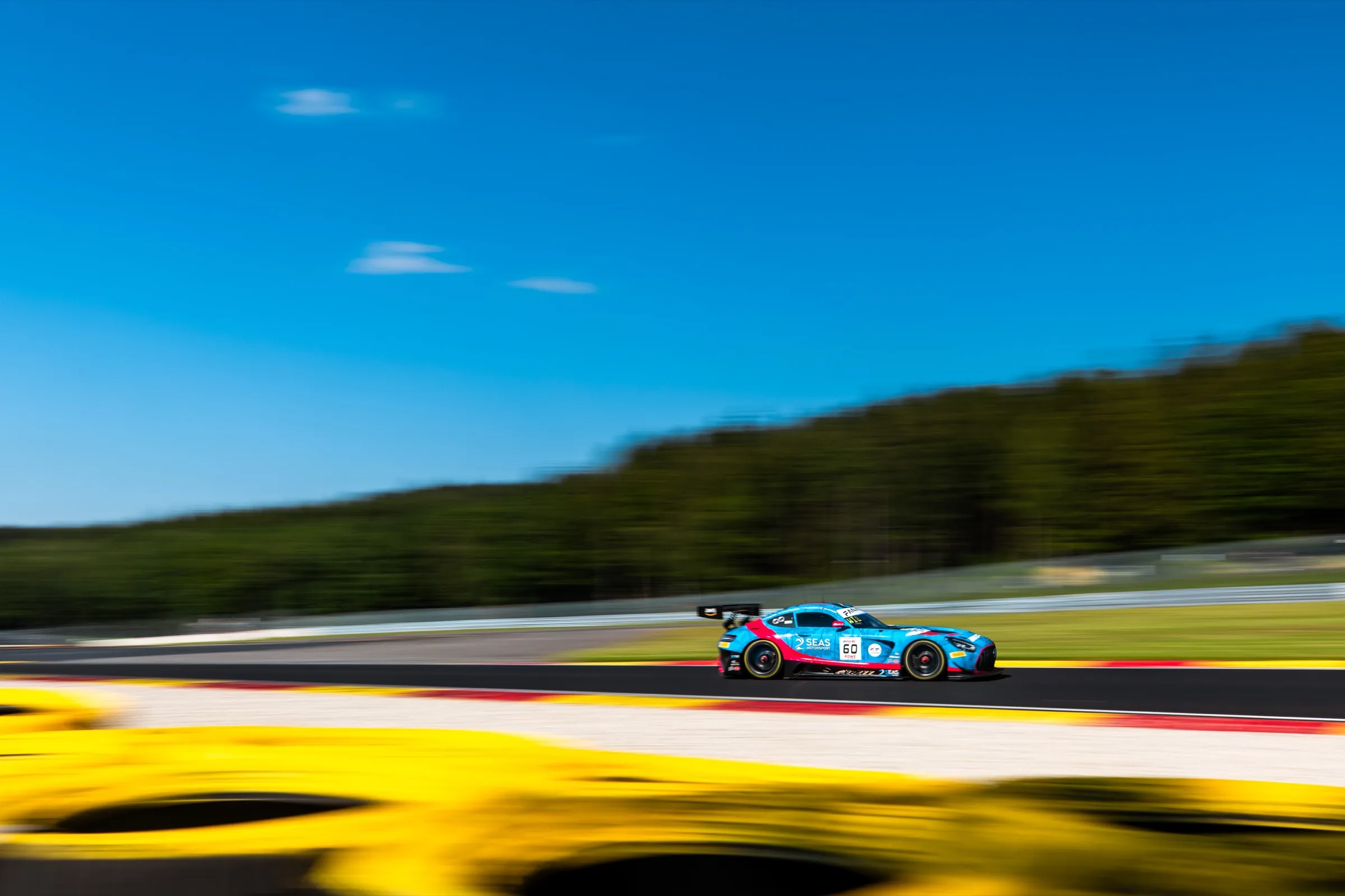 GT3 car at speed on a sunny circuit