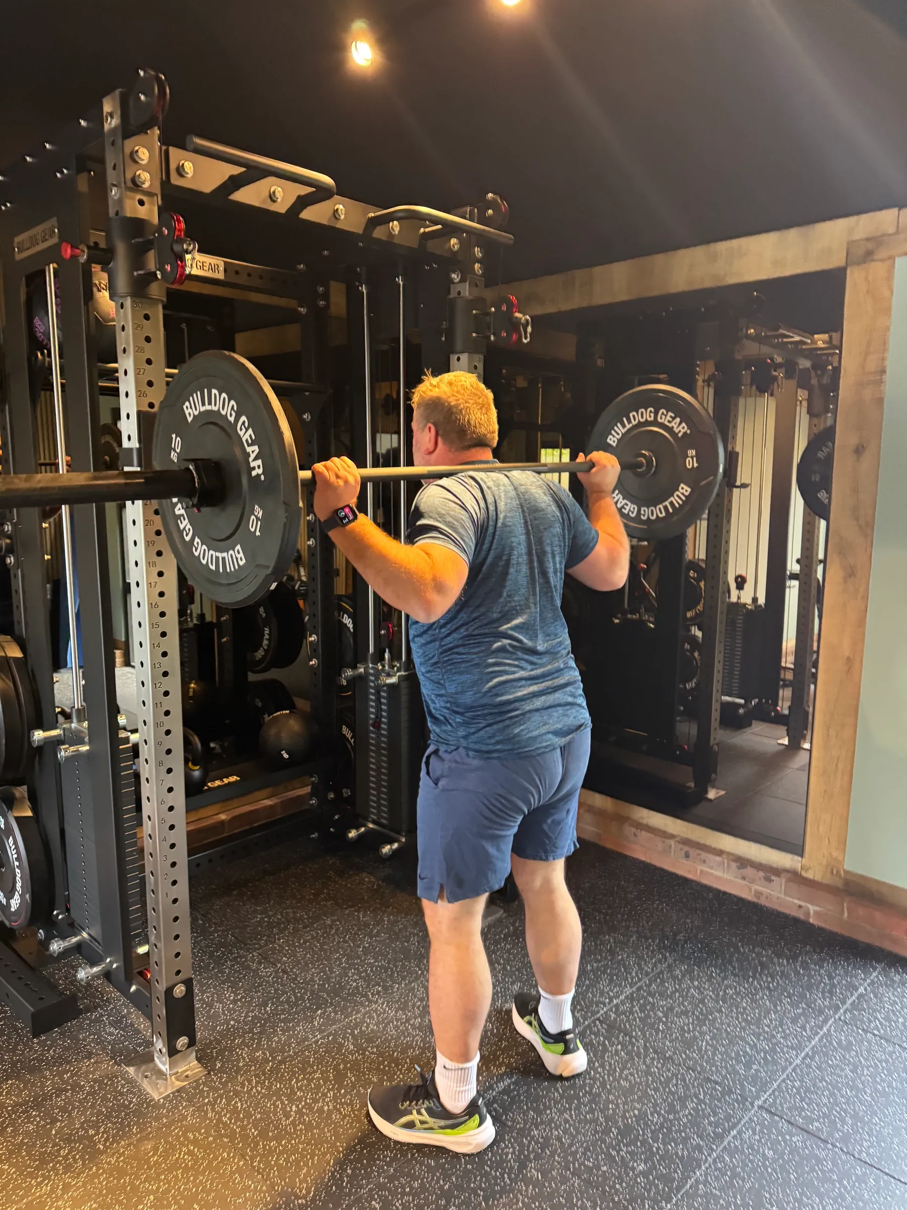 Adult client squatting in the gym