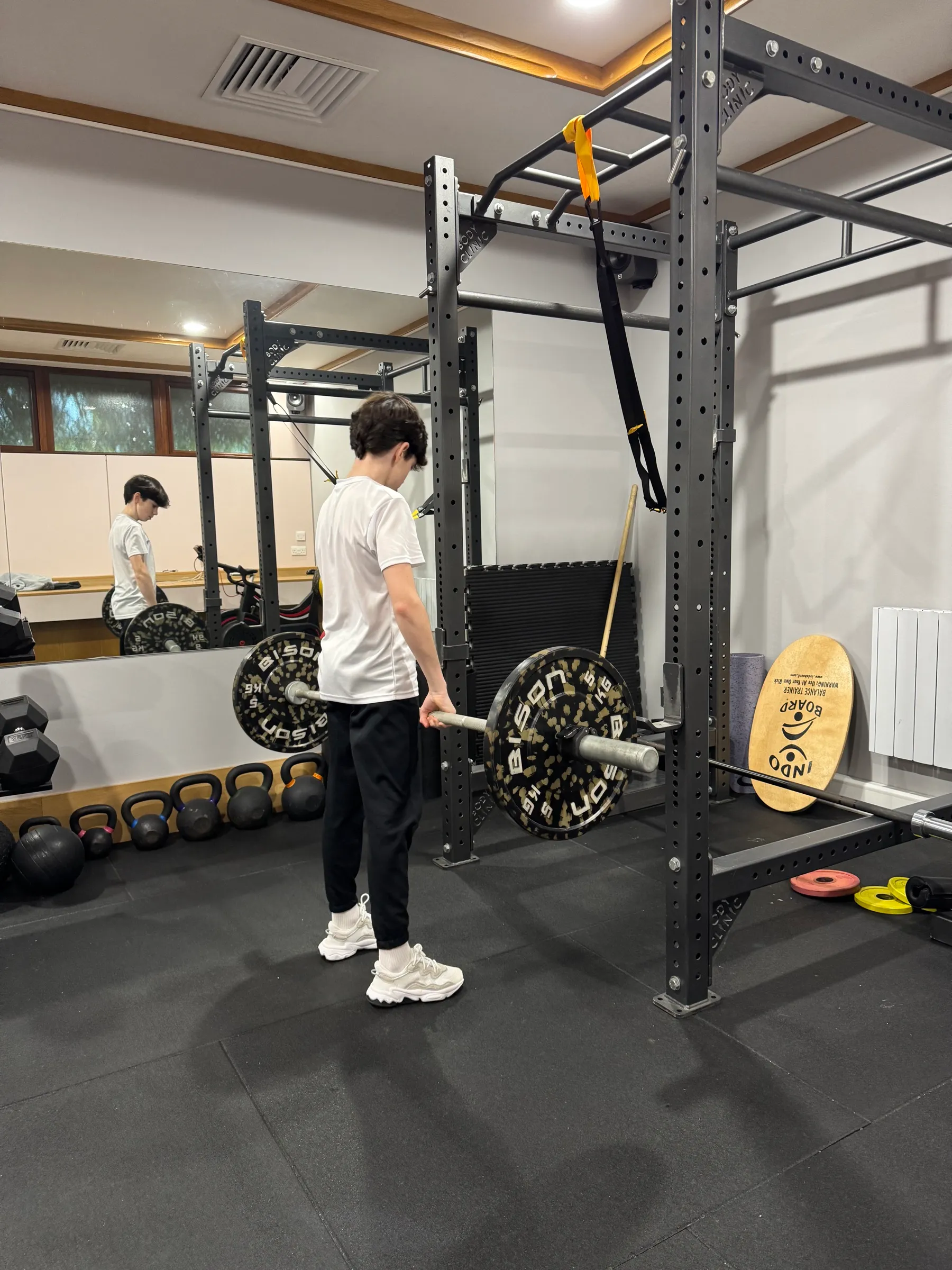 Young driver setting up under a squat rack