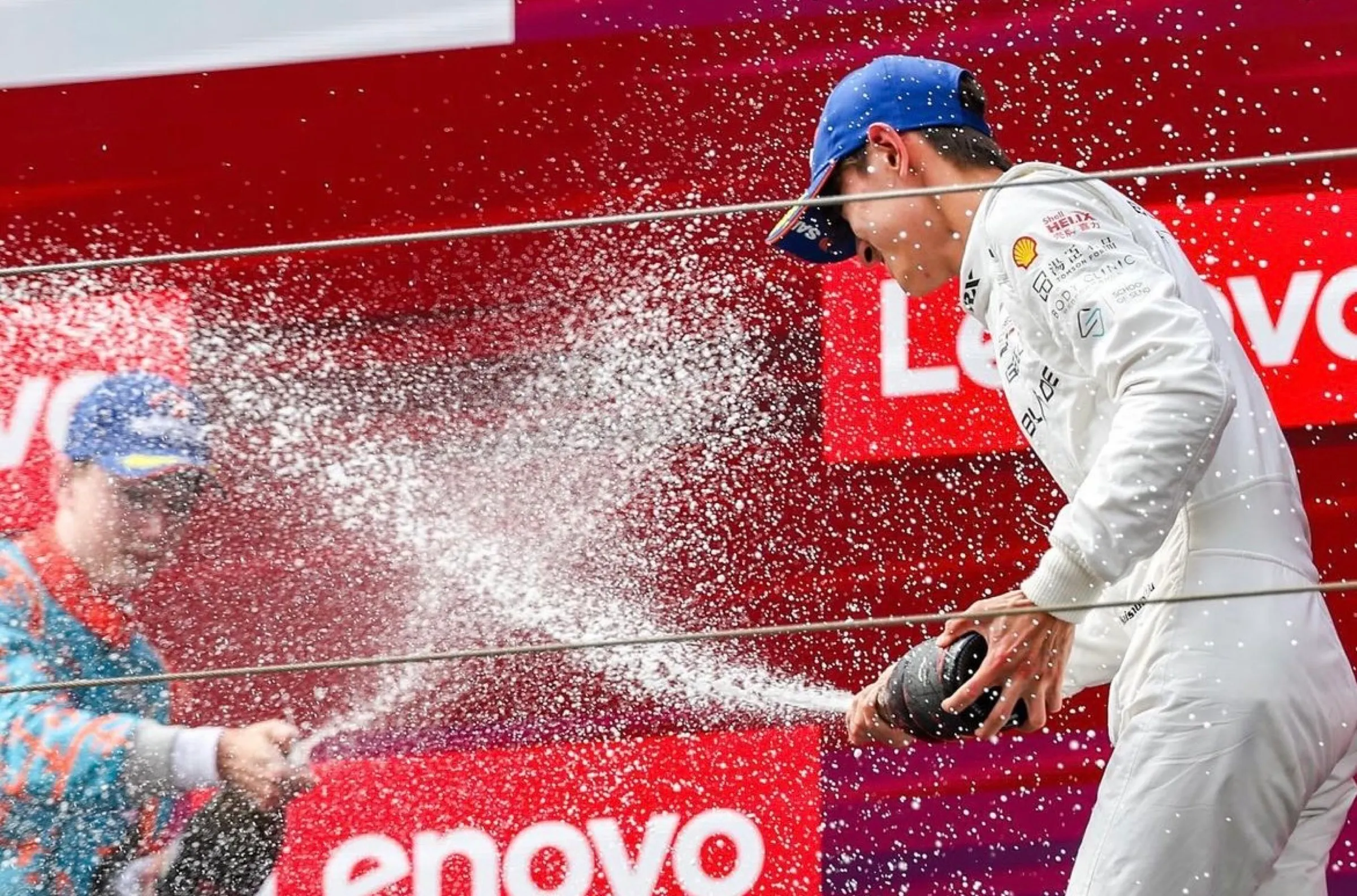 Driver spraying champagne on the podium